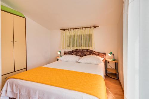 Postel nebo postele na pokoji v ubytování Apartments Kronja