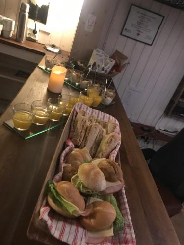 a table with a tray of sandwiches and glasses of orange juice at Hotell Karolinen Åre in Åre