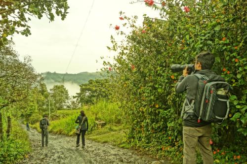people walking down a dirt road with a photographer taking a picture at Skale Peregrino in Choachí