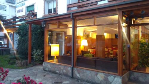 a glass building with a living room in it at Piuké in San Carlos de Bariloche