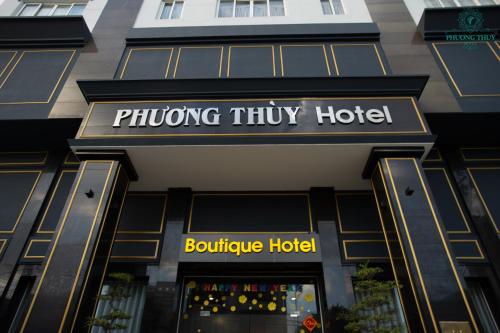 a building with a sign for a shooting tiny hotel at Phuong Thuy Hotel Thu Duc near QL13 in Ho Chi Minh City