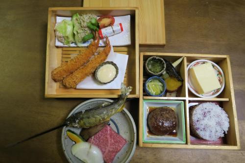 a tray of food with vegetables and other foods at Katsuragi no Sato in Takayama