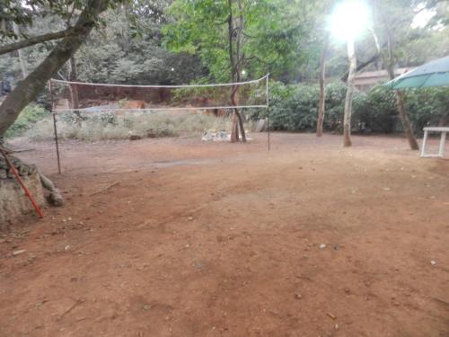 a volley ball net on a dirt field at Sayeban Hotel in Matheran
