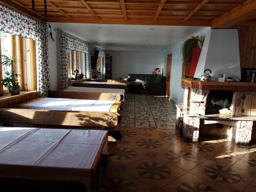 a room with several beds and a fireplace at Antonówka in Trybsz