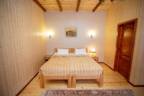 a bedroom with a bed and a dresser at MagHay B&B in Vanadzor
