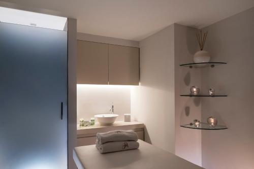 a small bathroom with a sink and a counter at Grand Hôtel des Alpes in Chamonix-Mont-Blanc