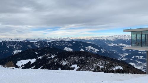 a snow covered mountain with a building on top of it at App. Tamanhof in San Giorgio