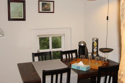 a dining room with a wooden table with chairs at B&B De Rumelshof in Hierden