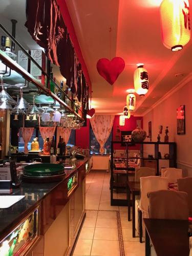 a restaurant with a bar with hearts on the wall at FANTASIA a spacious beautiful apartment & affordable in Nossegem