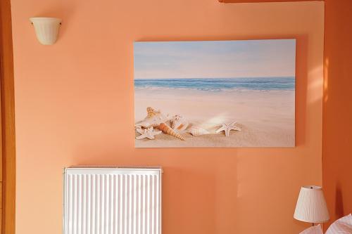 a picture of a beach with starfish on a wall at Hotel Pelagos Studios in Platána