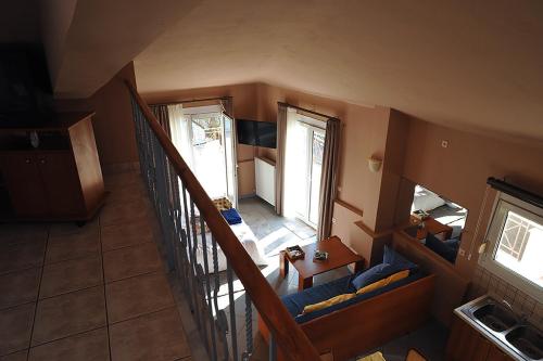 an overhead view of a living room with a staircase at Hotel Pelagos Studios in Platána