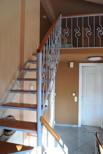 a spiral staircase in a house with a door at Hotel Pelagos Studios in Platána