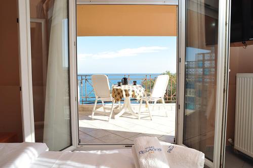 a room with a view of a table and chairs at Hotel Pelagos Studios in Platána