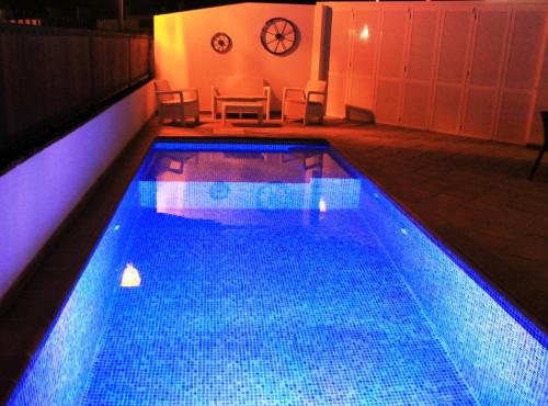 a large swimming pool with blue lights on it at Las Arecas Mansion in Playa Blanca
