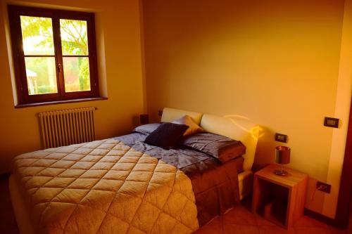 Mugello Tuscany Bosso di Sopra في بورغو سان لورينزو: غرفة نوم بسرير ونافذة