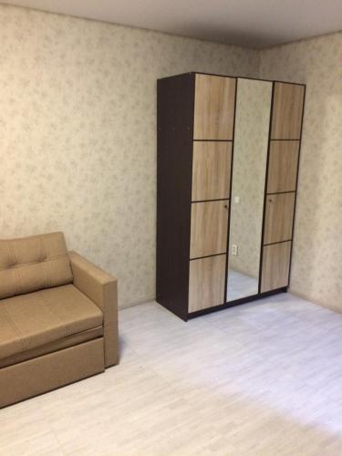 a living room with a couch and a mirror at Mega city in Kyiv