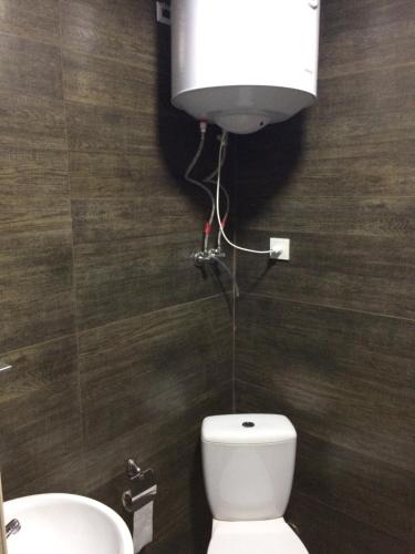 a bathroom with a white toilet and a sink at Mega city in Kyiv