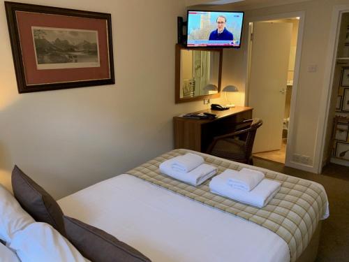 a hotel room with a bed and a flat screen tv at The Albany St Andrews in St. Andrews