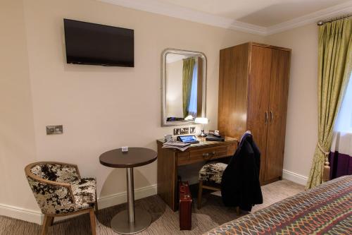 a hotel room with a desk and a bed at Grand Hotel Tralee in Tralee