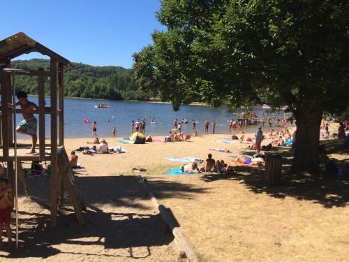 - un groupe de personnes sur la plage d'un lac dans l'établissement Studio duplex 1 Lac des Montagnès, à Mazamet