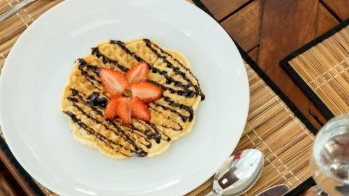 a plate of food with strawberries on it at Deltora Villa - free drop off to Galle Fort by TukTuk in Galle