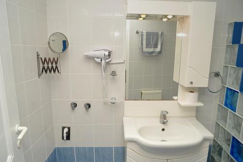 a bathroom with a toilet and a sink and a mirror at Hotel Pelagos Studios in Platána