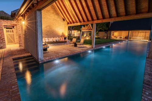 an infinity pool in a backyard with a house at 7 Koppies in Franschhoek