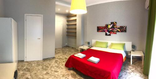 a bedroom with a red bed with a red blanket at CAVOUR 124 -guest-room- in Bari