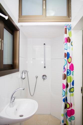 a bathroom with a sink and a shower curtain at GK apartment Beauty in Bat Yam