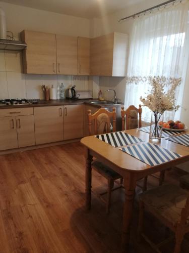 a kitchen with a wooden table and a dining room at Tysiąclecia 11/1 in Piechowice