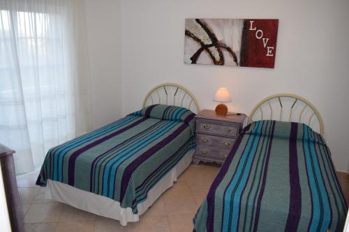 two beds sitting next to each other in a bedroom at CasaDuarte "Varanda" in Lagos