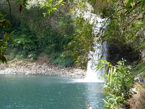 a waterfall in the middle of a river at L'Orée du Maïdo in Le Guillaume