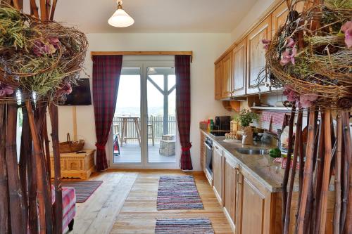 a kitchen with wooden cabinets and a door to a balcony at Landvilla Pia in Attendorf