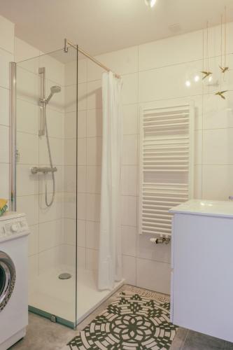 a bathroom with a shower with a glass door at SOEPP hotel & restaurant in Alkmaar