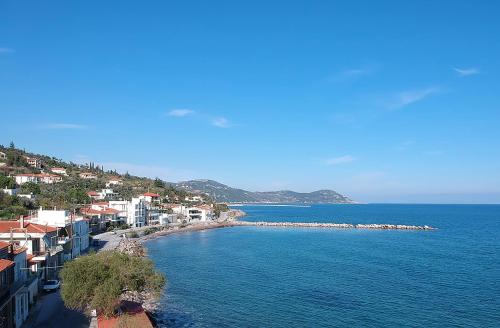 a view of a beach with houses and the water at Hotel Pelagos Studios in Platána