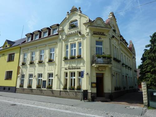 a yellow building on the side of a street at Hotel & Restaurant Na Fryštátské in Karviná