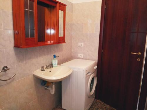 a bathroom with a sink and a toilet and a sink at Su Cuile historical country house with barbecue in Martis