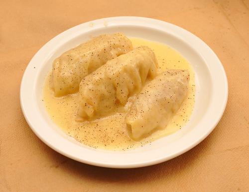 a plate of dumplings with sauce on a table at Hotel Pelagos Studios in Platána