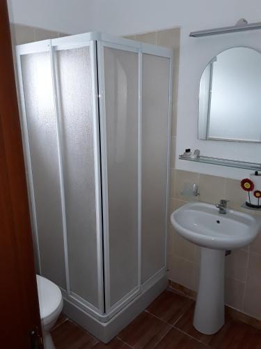 a bathroom with a sink and a shower and a toilet at Citrus Tree Gardens in Kyrenia