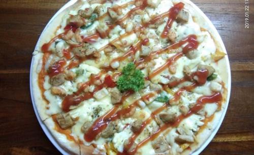 a pizza sitting on top of a table at Pemedal Beach Resort in Nusa Lembongan