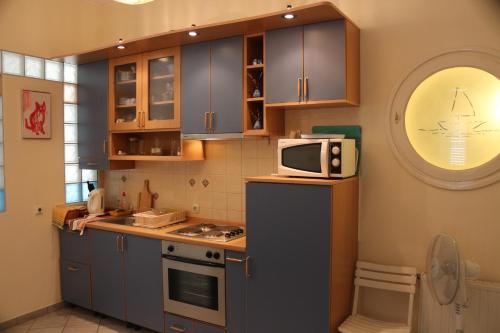a kitchen with a microwave on top of a refrigerator at Green Market Apartment in Opatija