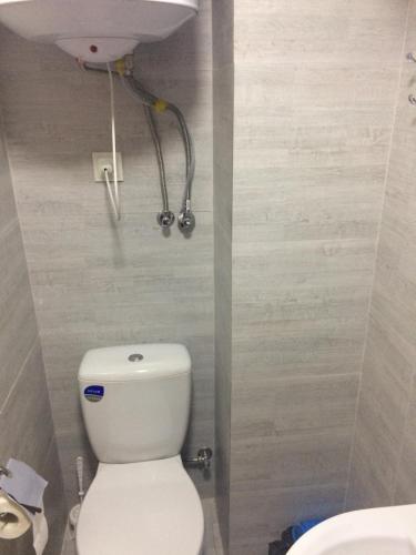a bathroom with a white toilet and a sink at Mega city in Kyiv