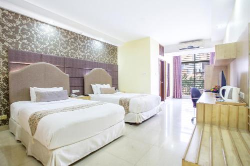 Ένα ή περισσότερα κρεβάτια σε δωμάτιο στο Ascott The Residence - Baridhara, Dhaka
