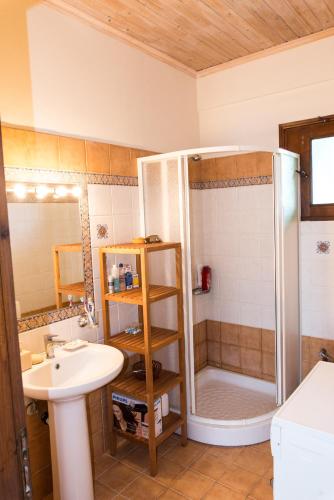 a bathroom with a shower and a sink at Villa with private garden in Kréstena