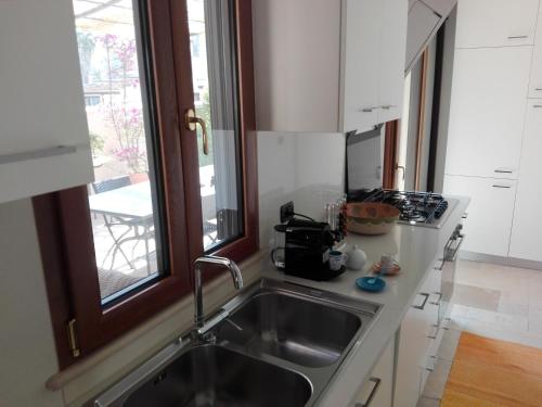 a kitchen with a sink and a window at L'Antico Pergolato Apartments in Brindisi