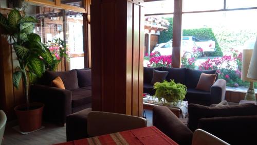 a living room with couches and a large window at Piuké in San Carlos de Bariloche