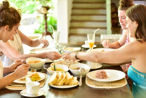 a group of women sitting around a table eating food at Aurora in Unawatuna
