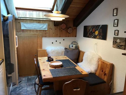a dining room with a table and a couch at Chalet Memory in Zermatt