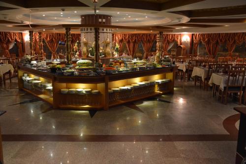 a buffet in a restaurant with tables and chairs at Canary Beach Hotel in Yanbu