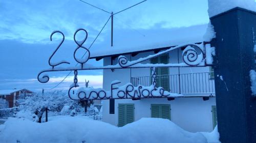 a sign for a house covered in snow at Casa Fornace 28 in La Morra